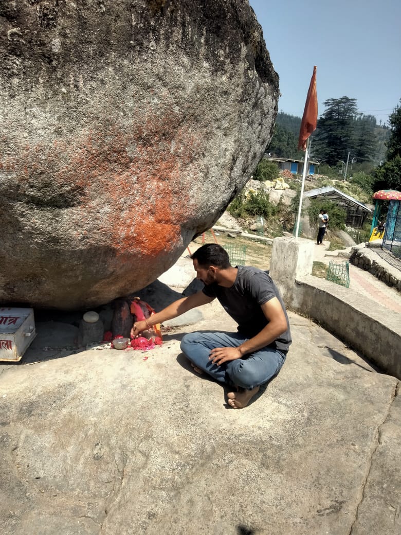 Discover Pandav Shila, the Janjheli Valley's Historical Gem 3 picture of a perosn worshiping pandav shila in janjehli 1723095766